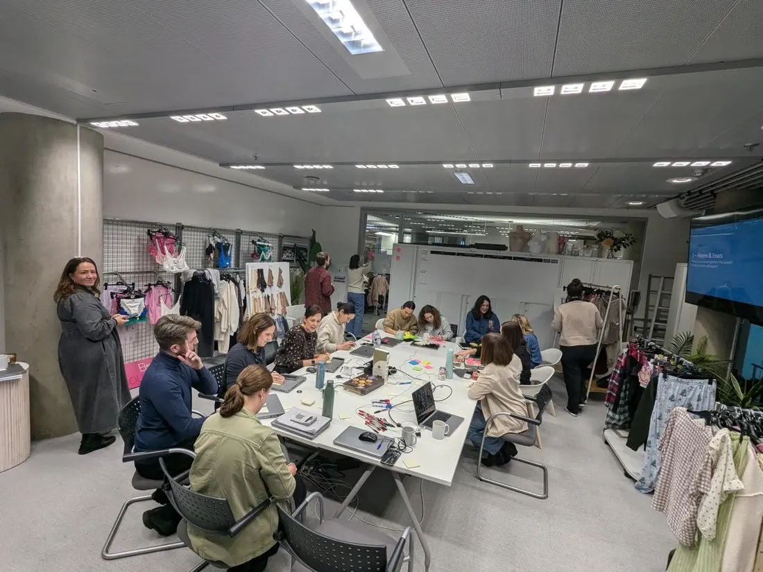 A team working together around laptops and sticky notes